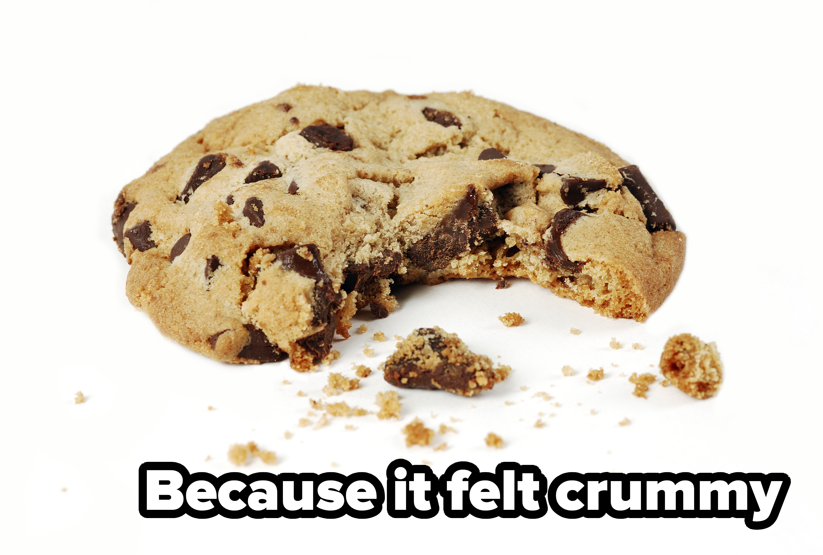 Chocolate chip cookie with a bite taken out, surrounded by scattered crumbs