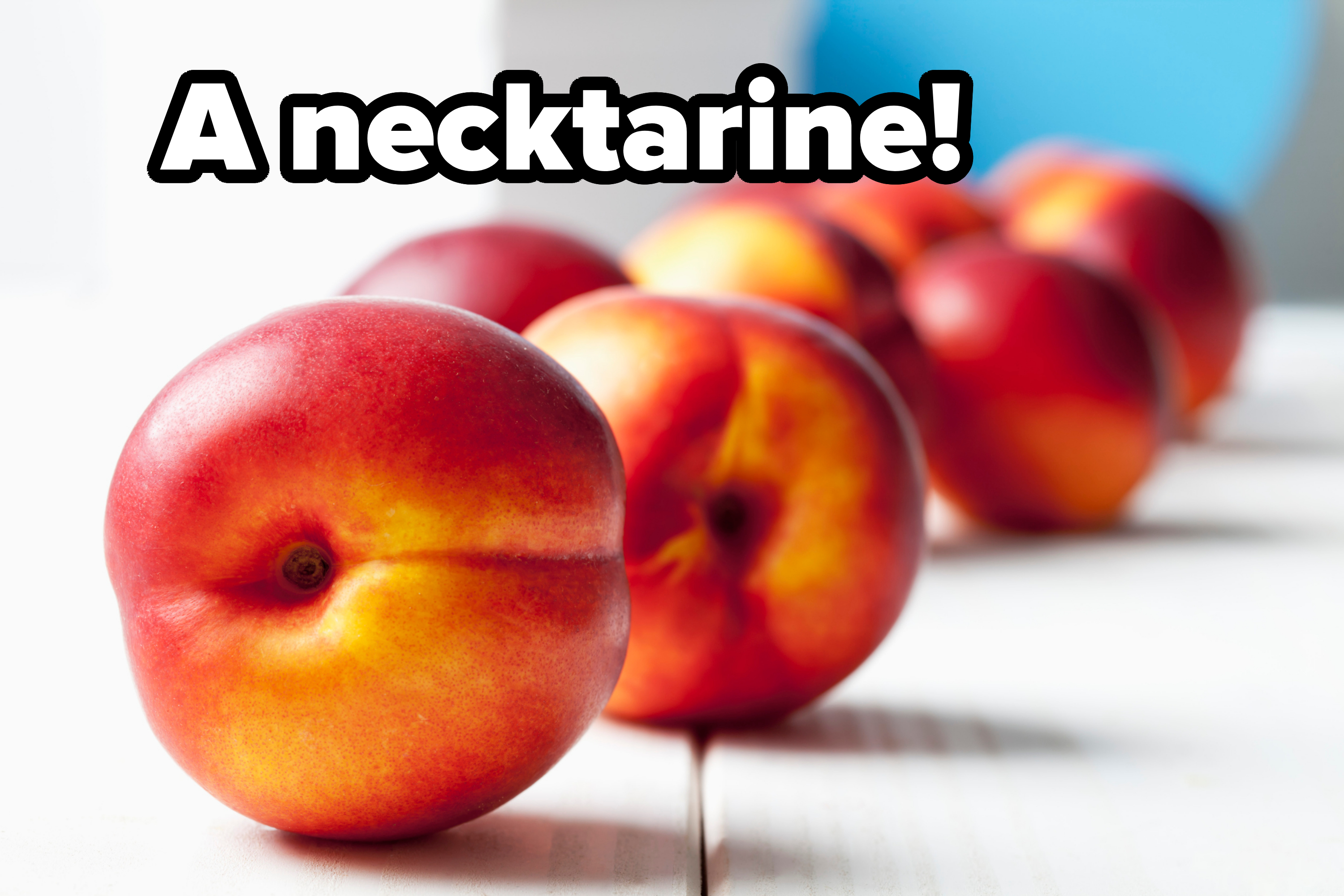 Close-up of ripe nectarines on a wooden surface, gradually fading out of focus in the background