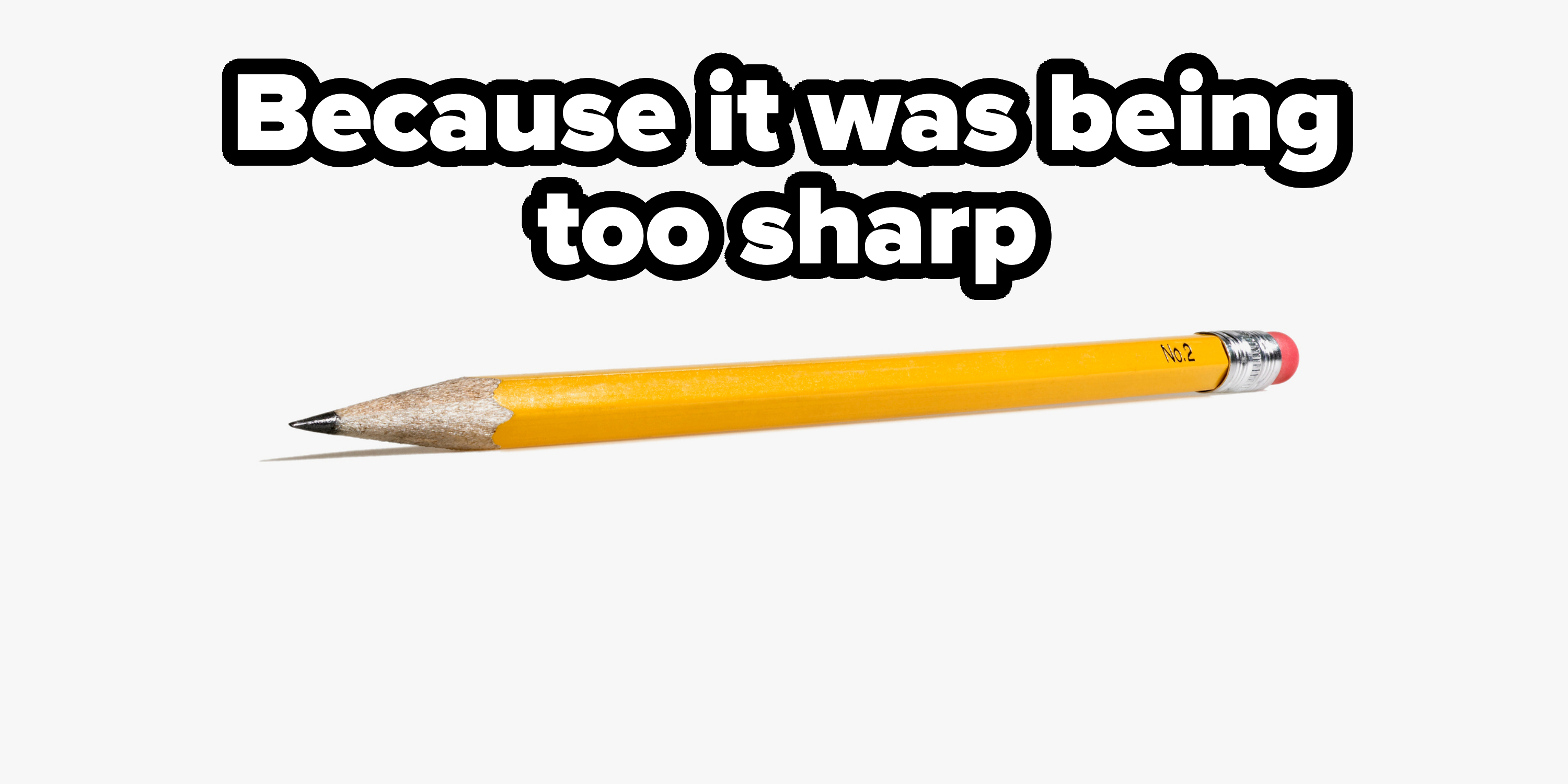 A yellow wooden pencil with a sharpened tip and a pink eraser is lying on a plain surface