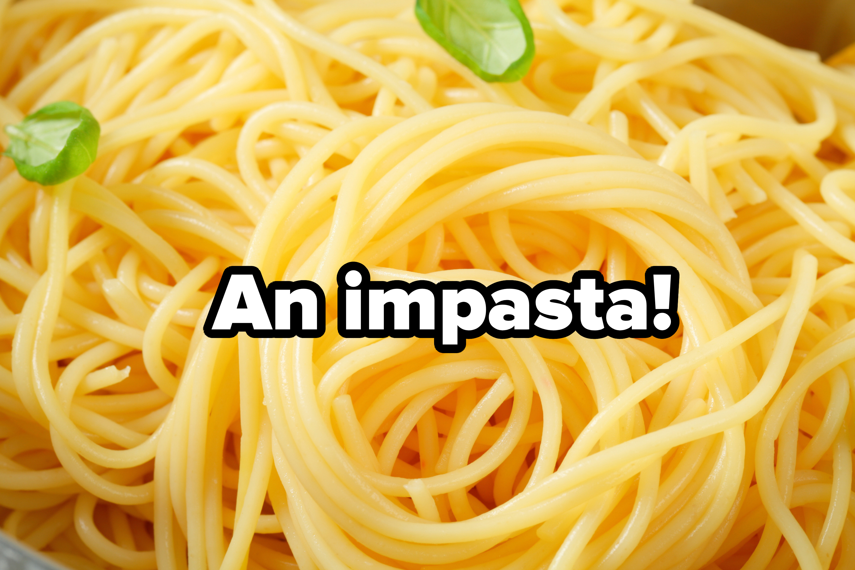 Close-up of cooked spaghetti with basil leaves on top