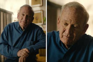 Man in a casual button-up shirt sits indoors, appearing thoughtful. He is photographed in a candid moment, suggesting a reflective or personal setting