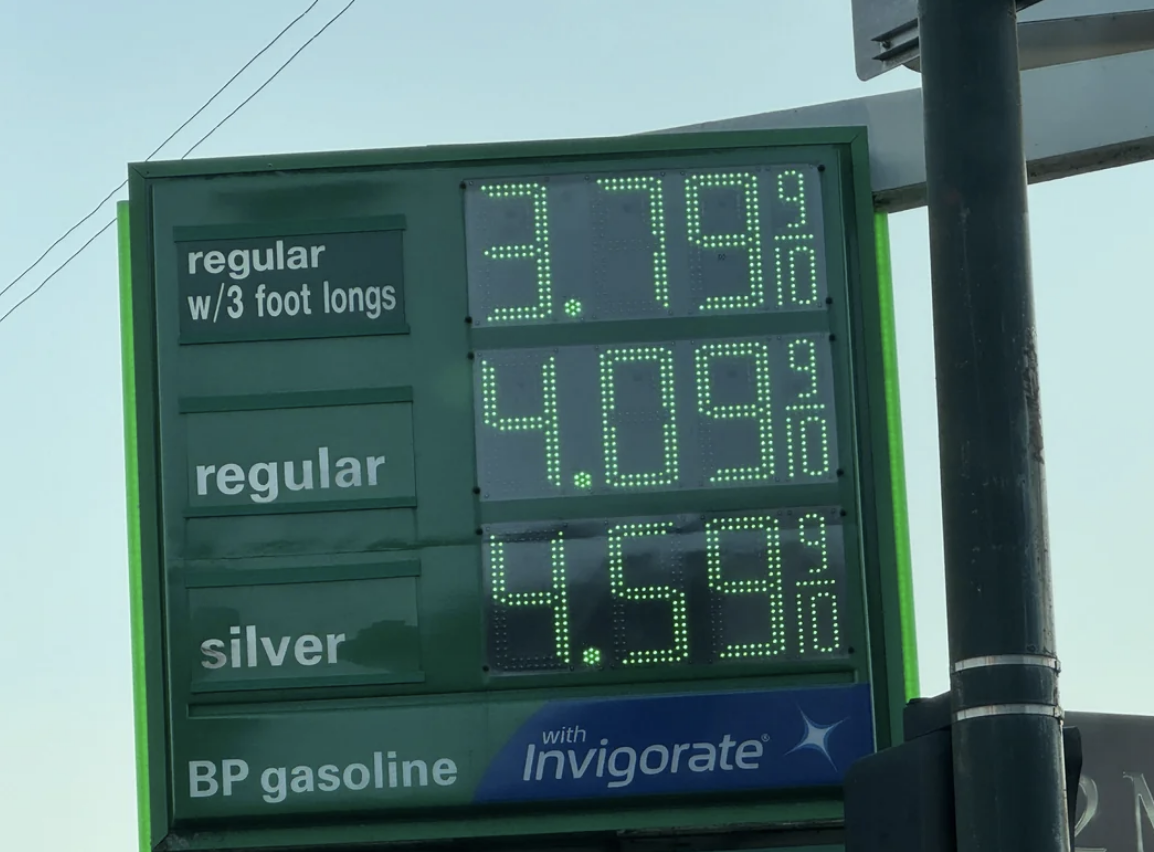 Gas station sign displays prices: $3.79 for regular with 3-foot longs, $4.09 for regular, and $4.59 for silver