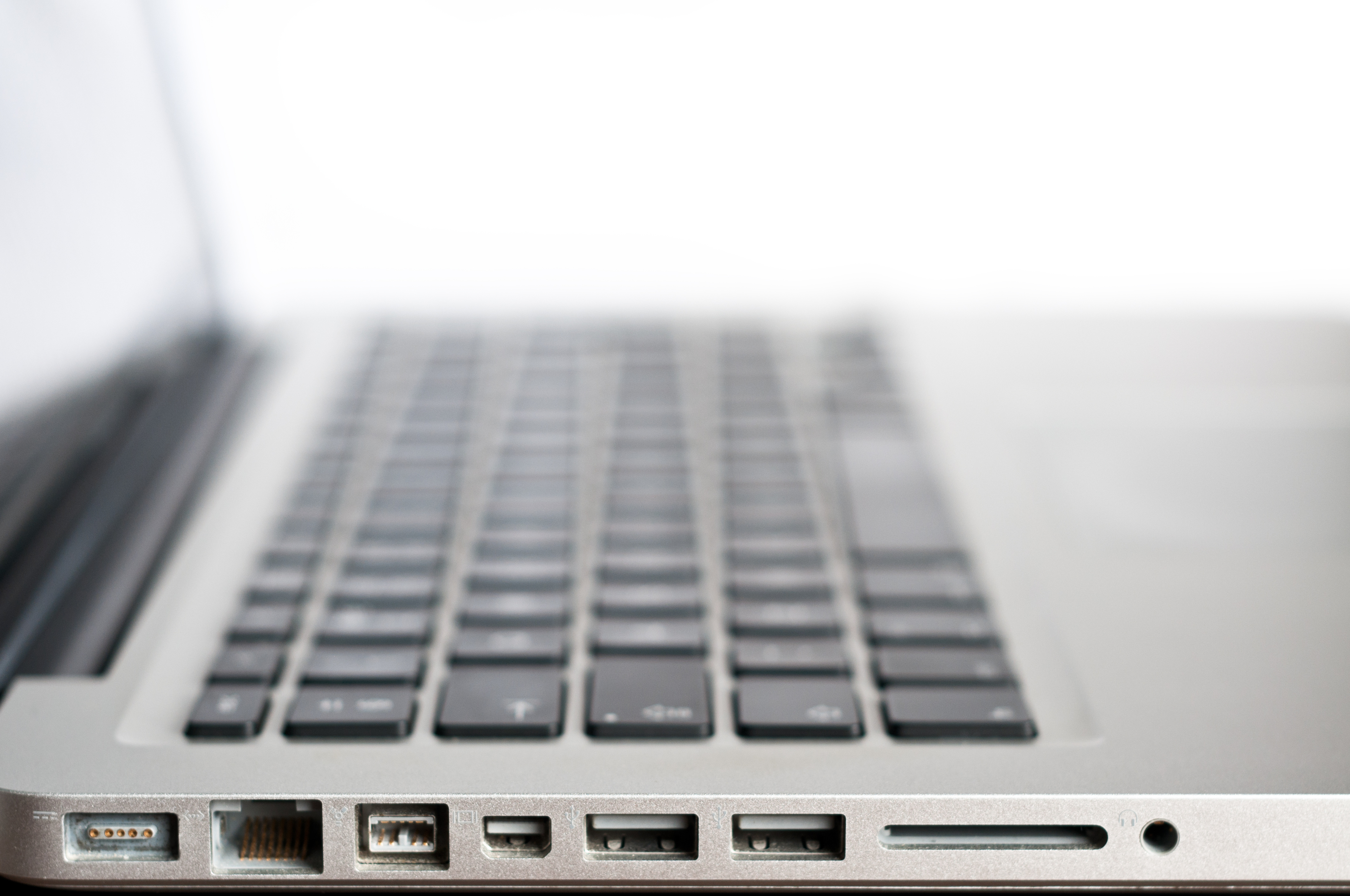 Close-up of a laptop&#x27;s side, showing various ports and the keyboard