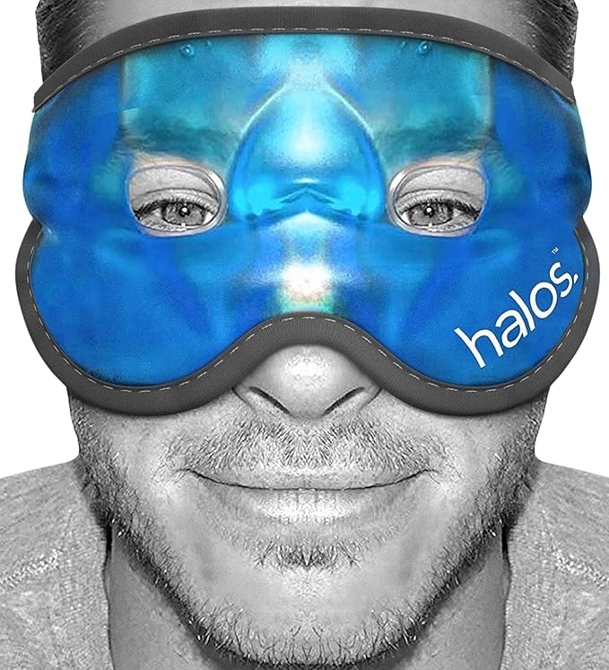 Man wearing a cooling eye mask labeled &quot;halos,&quot; with eyes visible. The mask is designed for relaxation or soothing purposes