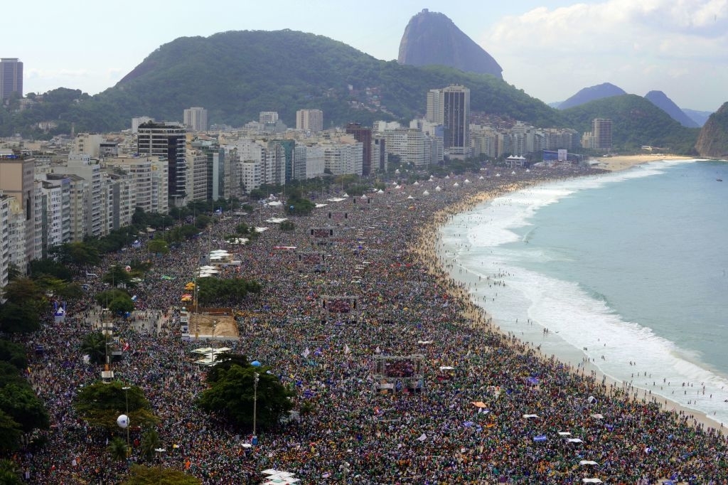 Massive crowd fills Copacabana Beach, Rio de Janeiro, with city skyline and Sugarloaf Mountain in the background