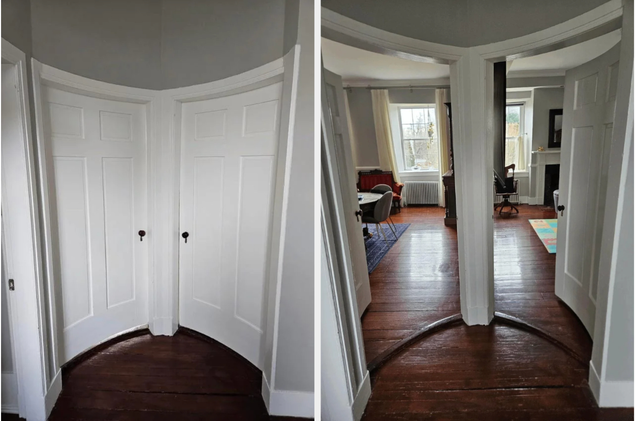 A curved wall with a hidden door reveals a cozy living room with armchairs and natural light