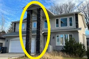 House with very tall stone columns in front extending up to the second story roof, highlighting unusual architectural design