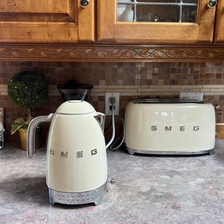 Smeg kettle and toaster set on a kitchen counter with backsplash