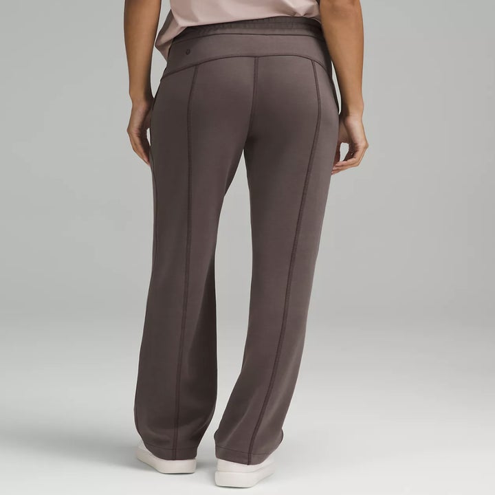 Back view of a person wearing high-waisted, wide-leg sweat pants, showcasing seam details