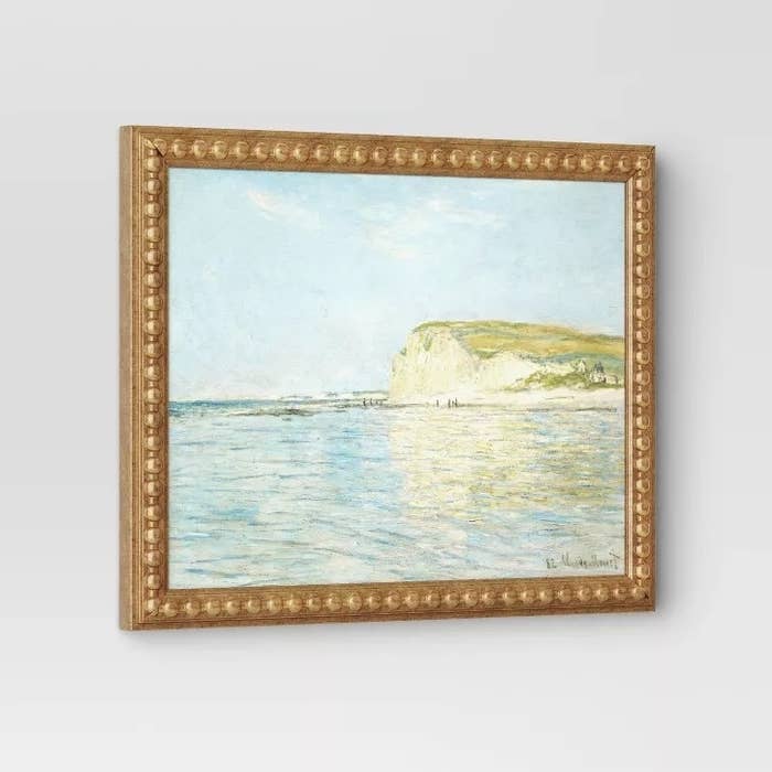 Framed seascape coating depicting cliffs and a calm sea, reflecting light. Suitable for location decor