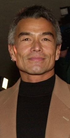 Three radical smiling astatine an event, with 1 wearing a denim jacket, different successful a sparkly dress, and the 3rd successful a suit jacket