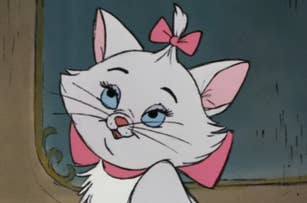 Marie from The Aristocats with bows on her head and neck, looking up with a happy expression