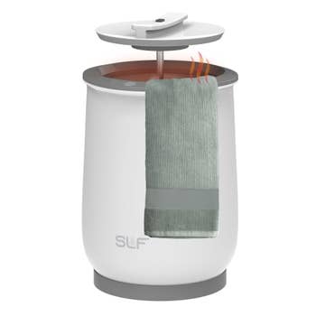 A towel warmer with a towel draped implicit the side, featuring a sleek, modern design, suitable for location use