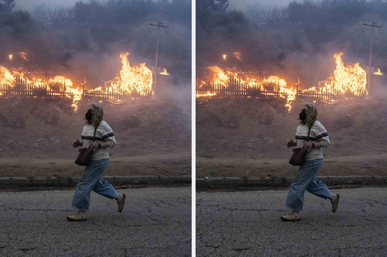 Person runs past a hillside fire, wearing a jacket and jeans, with smoke rising in the background. Emergency situation captured in an urban environment