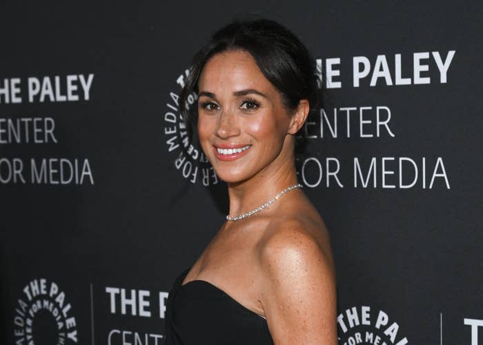 Person in elegant strapless dress posing at an event with 