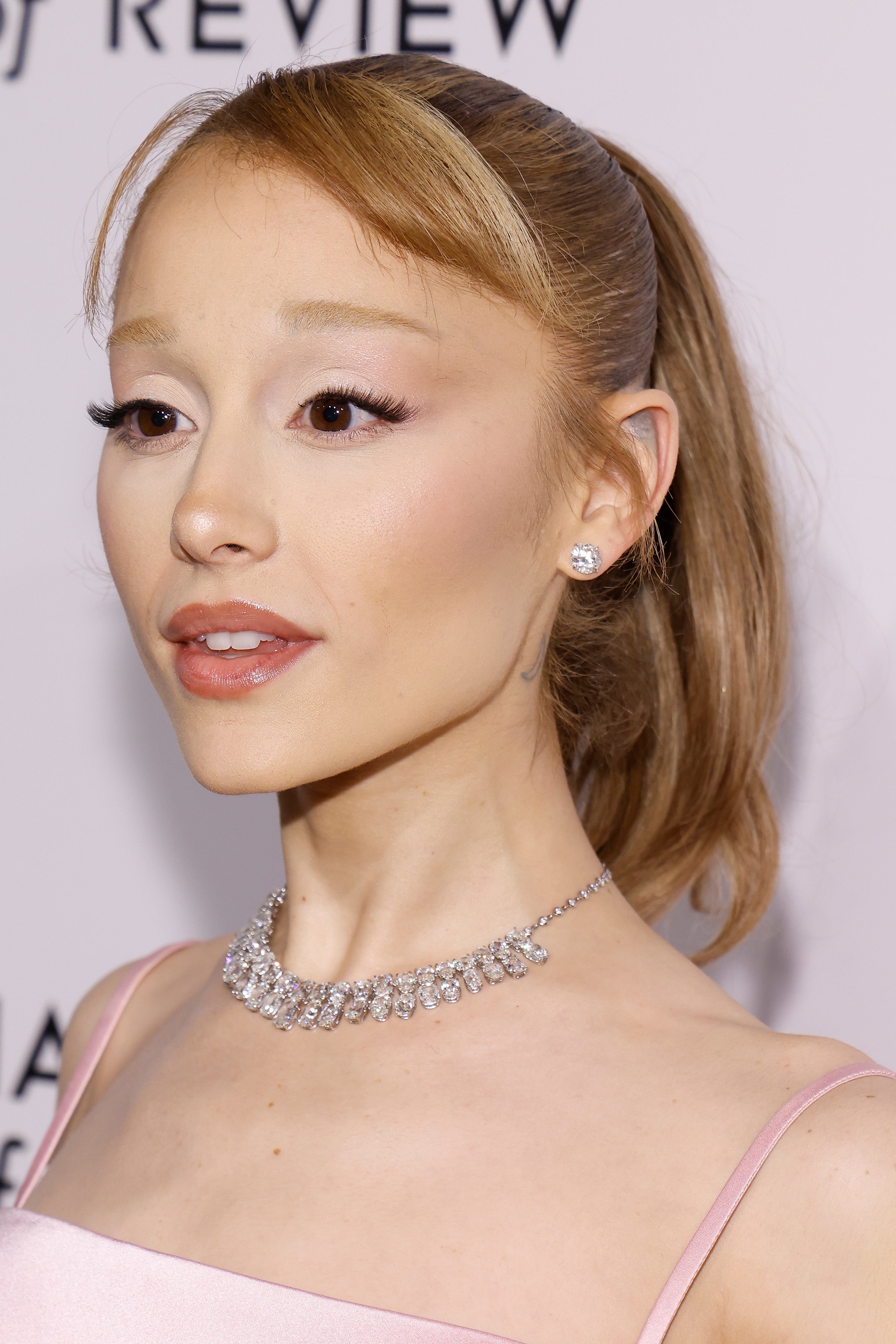 Ariana Grande in elegant attire with sleek hairstyle and diamond necklace at a celebrity event