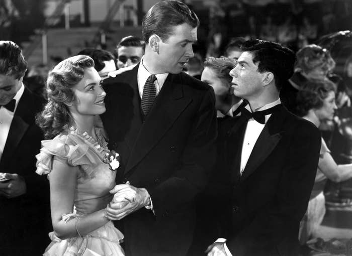 Donna Reed and Jimmy Stewart holding hands in a scene from "It's a Wonderful Life"