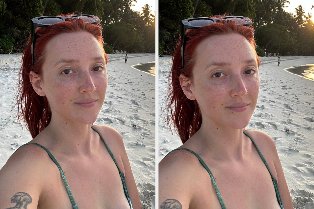 Person with red hair and green top takes a selfie on a beach at sunset, showing relaxed and natural look