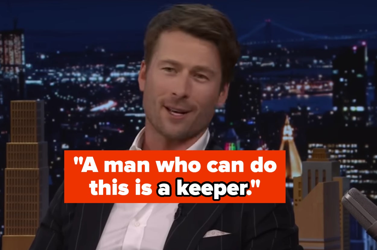 A man in a suit appears on a talk show set with a cityscape background. Text overlay: "A man who can do this is a keeper."