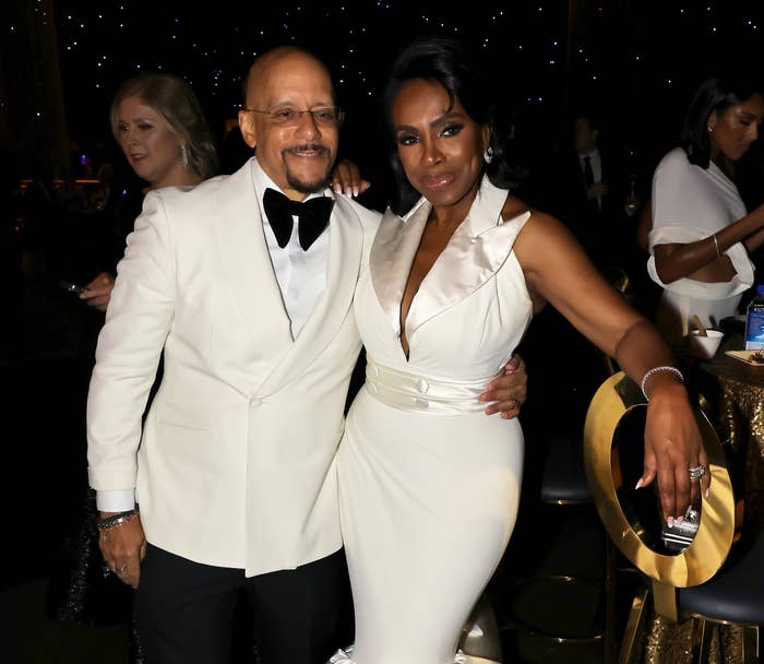 Vincent Hughes and Sheryl Lee Ralph  in elegant formal attire pose at an event. Vincent wears a tuxedo, and Sheryl wears a sleeveless gown with a ruffled neckline