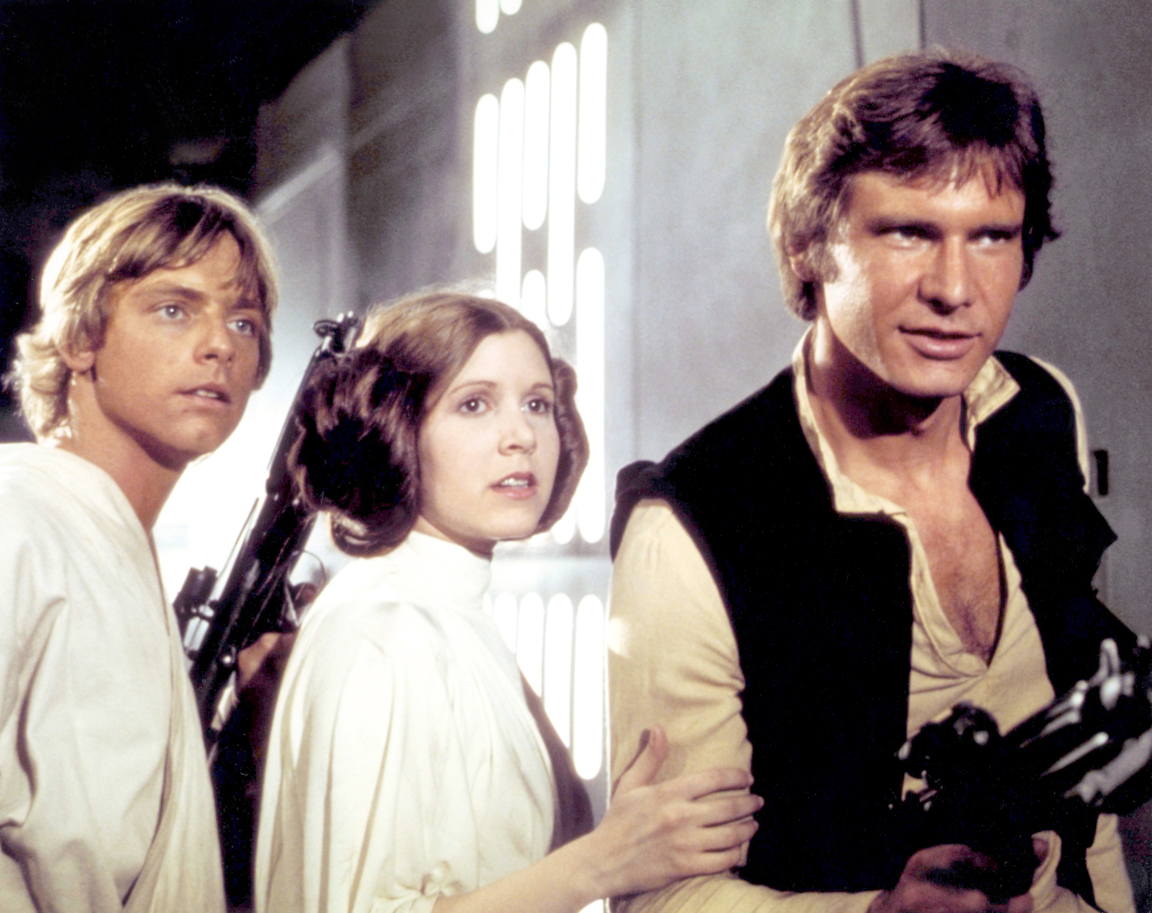 Mark Hamill, Carrie Fisher, and Harrison Ford as Luke and Leia Skywalker and Han Solo on the set of "A New Hope"