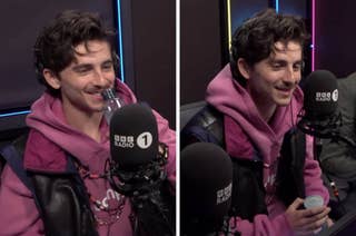 Person in a BBC Radio studio, wearing a casual pink hoodie and black vest, smiling and holding a water bottle