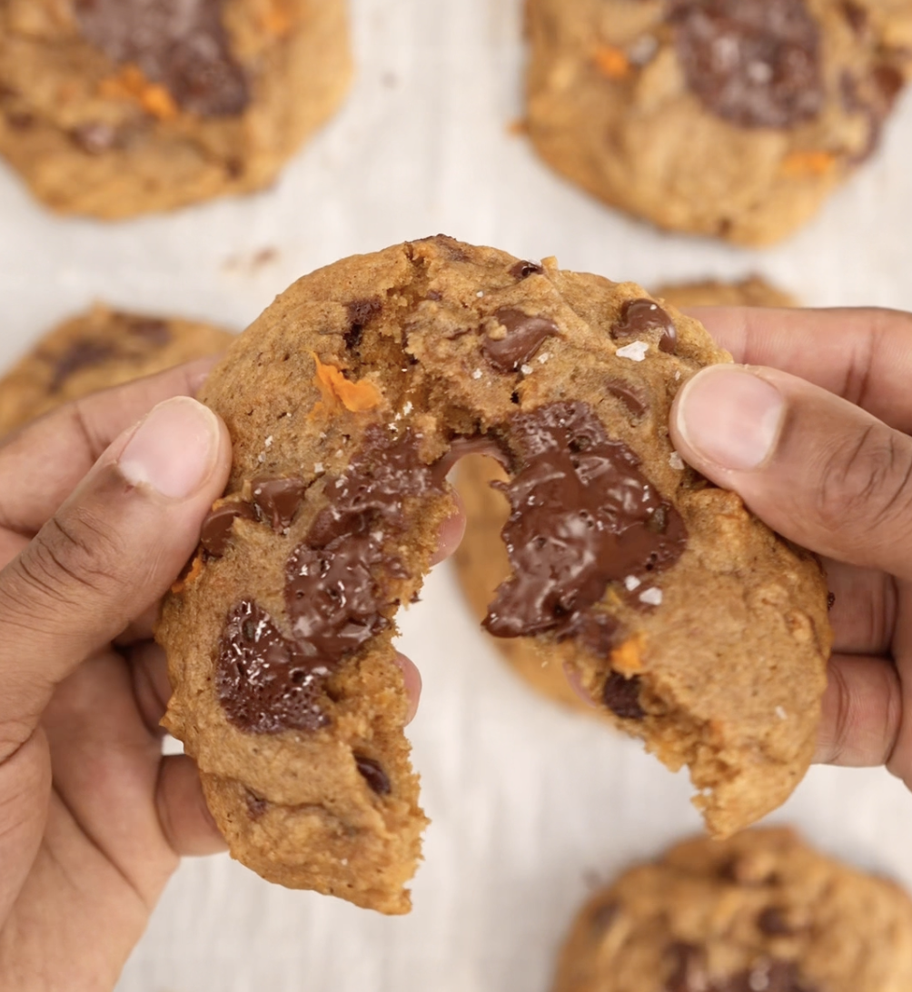 Person breaking a brushed  cocoa  spot   cooky  successful  half