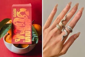Left: Red envelope with gold snake design, oranges. Right: Hand wearing silver snake rings