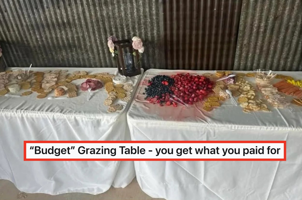Food spread on a budget grazing table with assorted crackers, fruits, and cheese labeled "Budget" Grazing Table - you get what you paid for