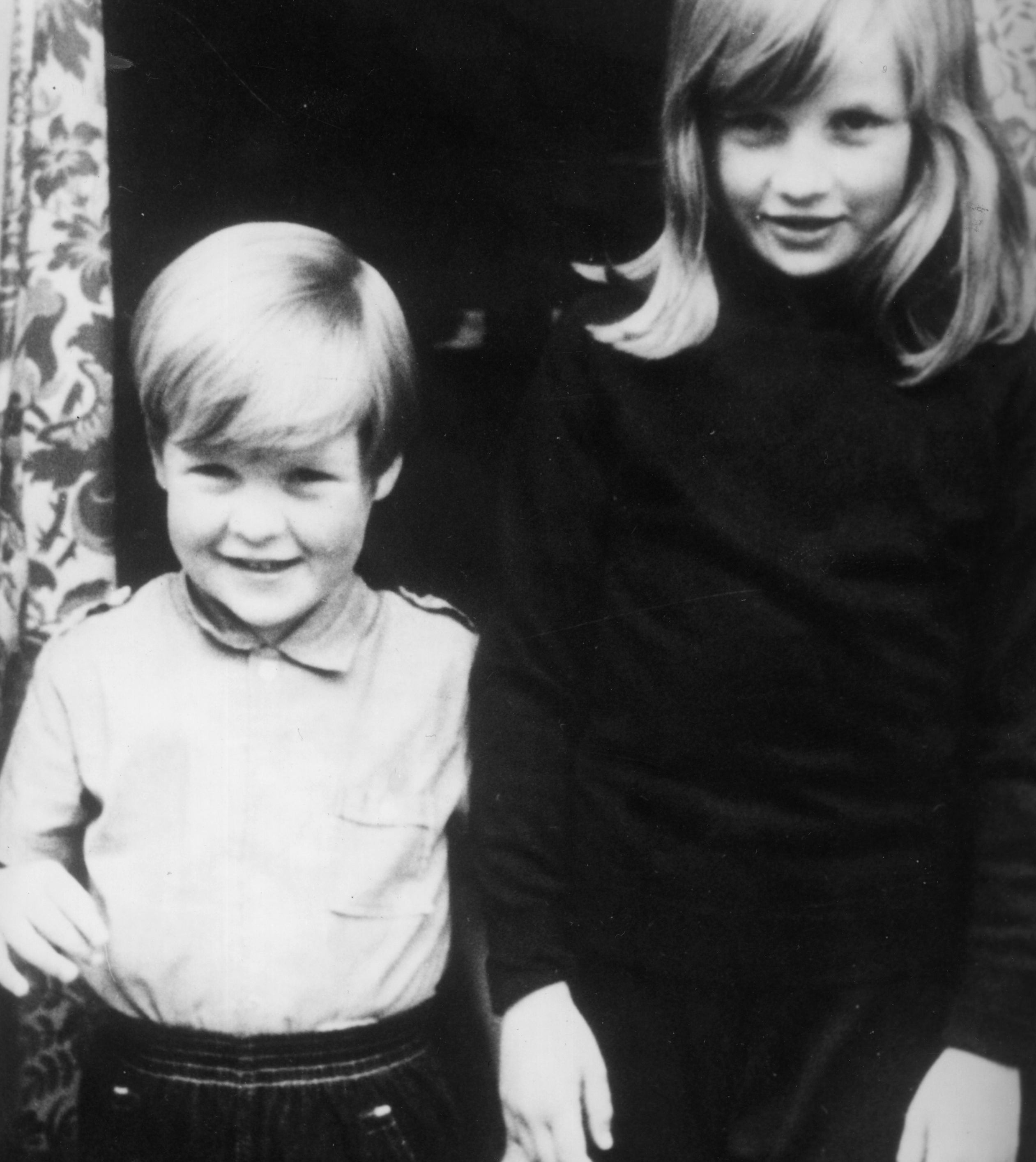 Charles Spencer and Princess Diana as children stand side by side, smiling
