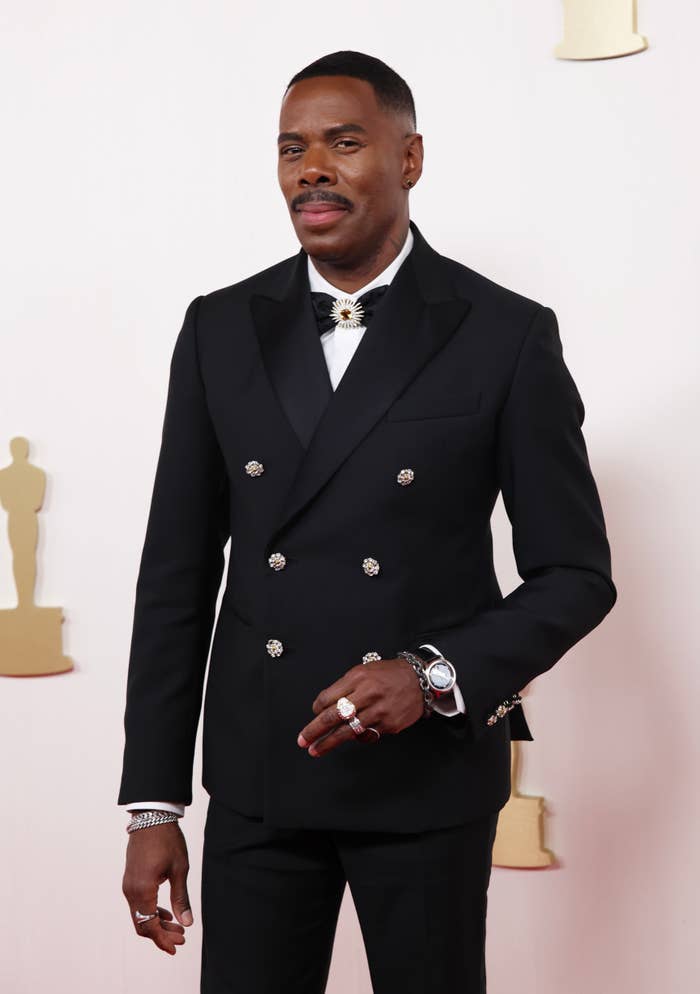 Colman Domingoi in a double-breasted suit with a bow tie on a red carpet