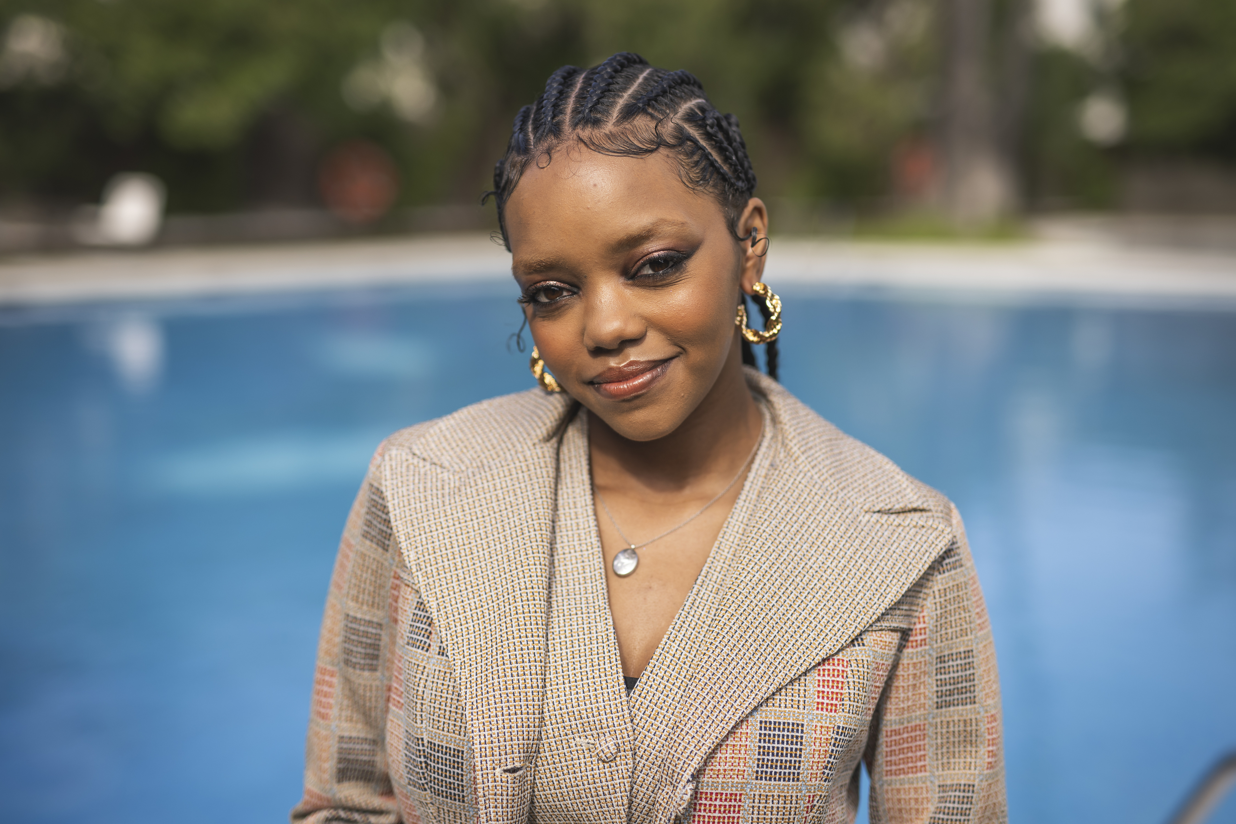 Regan Aliyah standing by a pool.