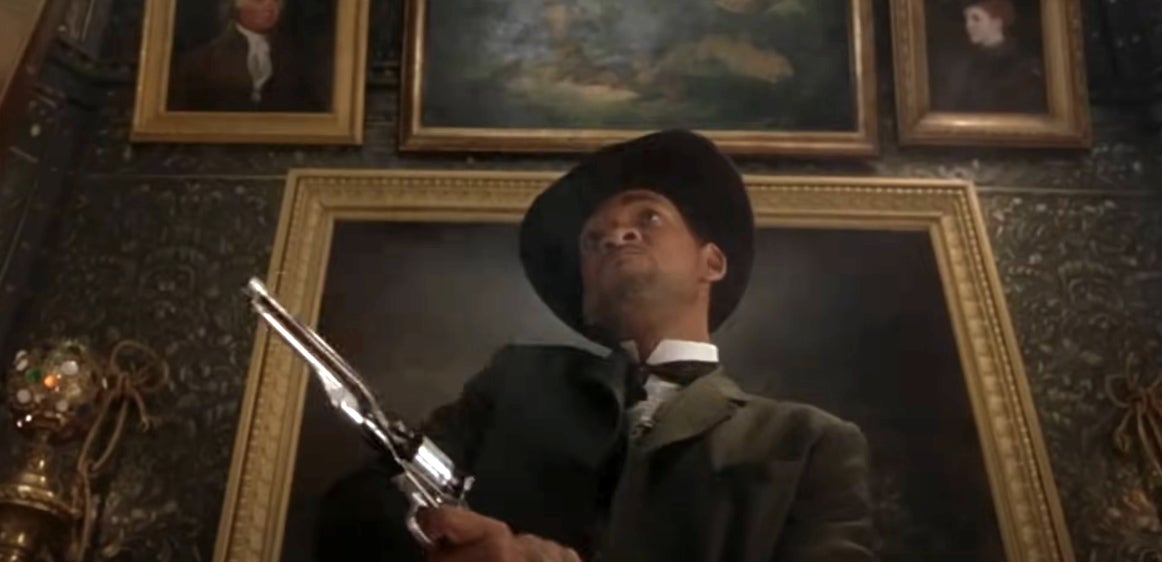 A person in period-style clothing and a hat dramatically points a large revolver upwards in a room with ornate paintings