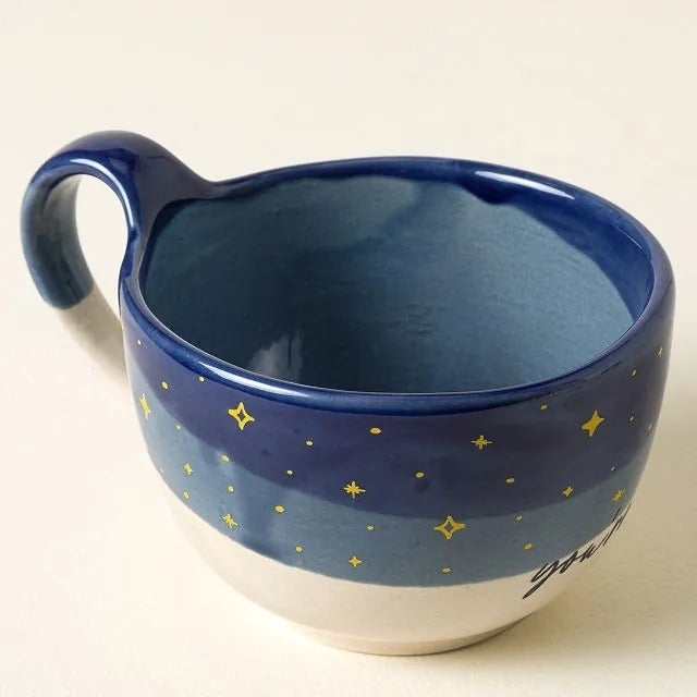 Ceramic mug with a starry entity  plan  connected  the precocious    half, suitable for holding beverages; featured successful  a buying  article