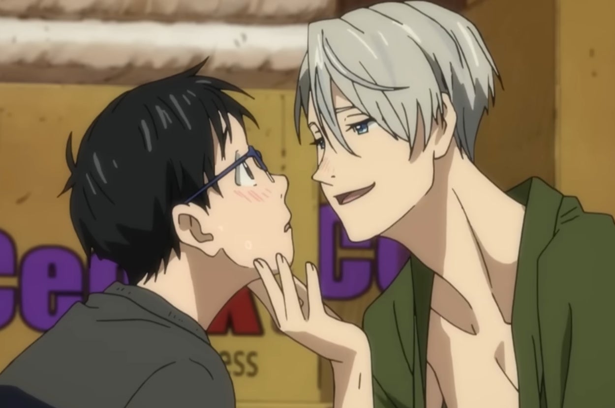 Two animated characters, one gently holding the other's chin, are in a close, intimate moment