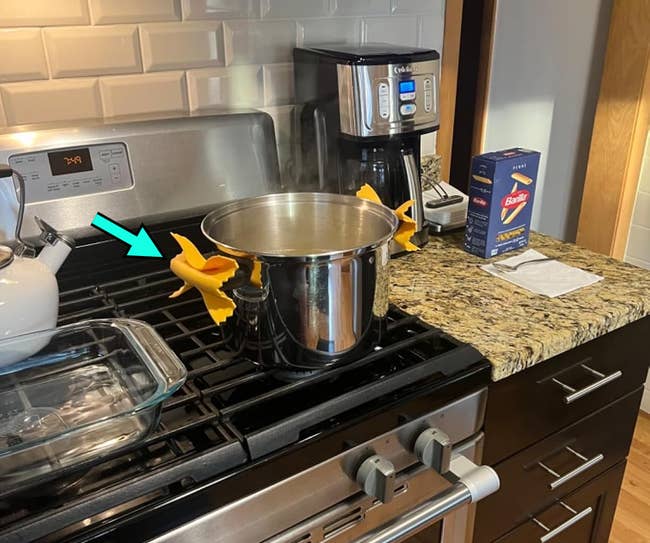 Pasta cookware connected stove with container of Barilla spaghetti; room setup includes a java shaper and teapot nearby
