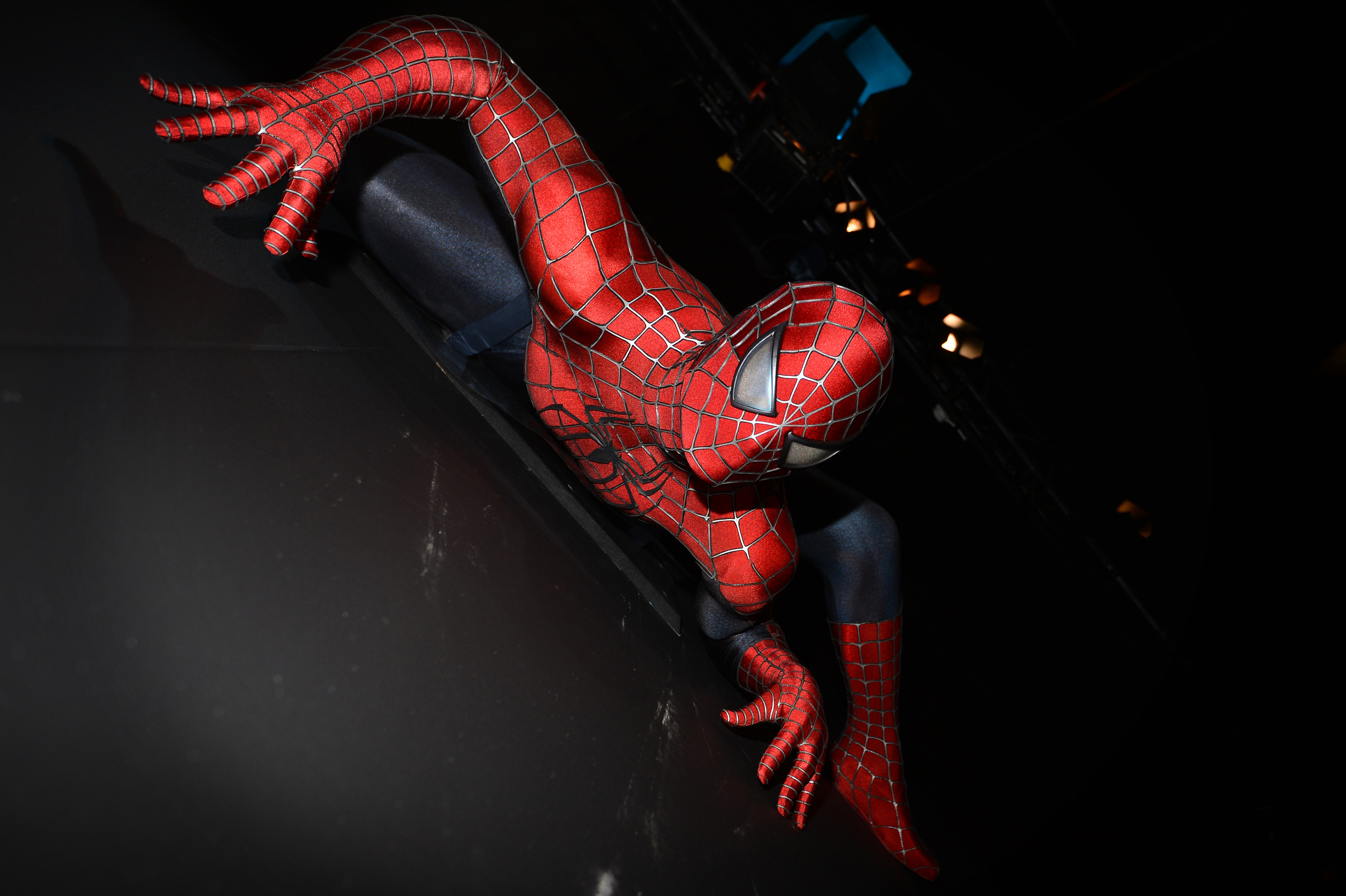 Spider-Man figure climbing a wall, captured at an angle showcasing the detailed costume