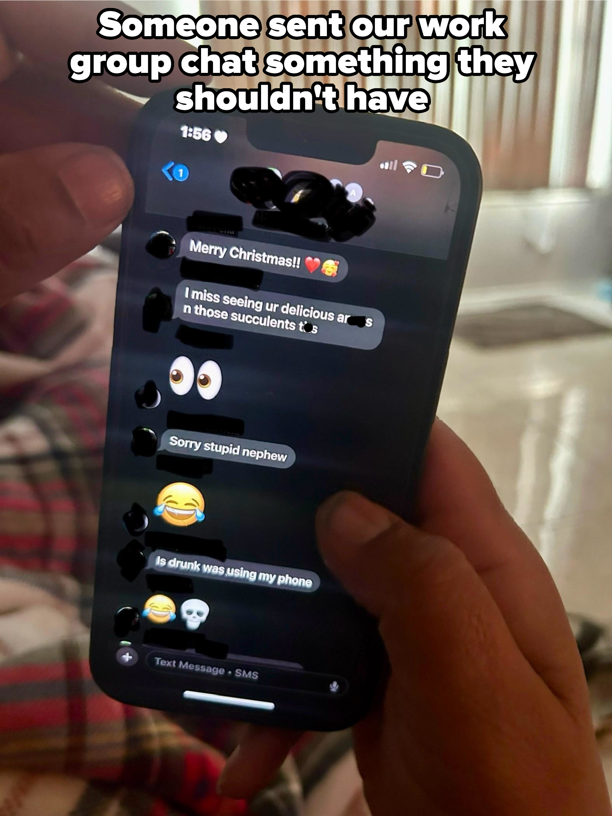 A person holds a phone displaying text messages, including &quot;Merry Christmas!!&quot; and a mix of emojis, with an apologetic message below