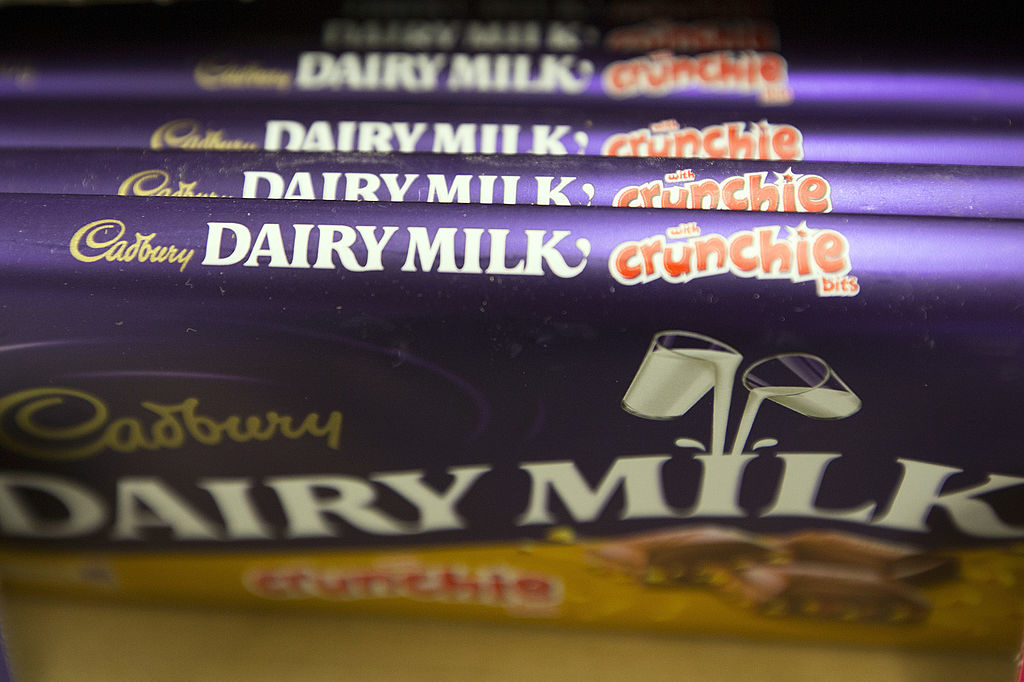 Rows of Cadbury Dairy Milk chocolate bars featuring &quot;Crunchie bits&quot; branding