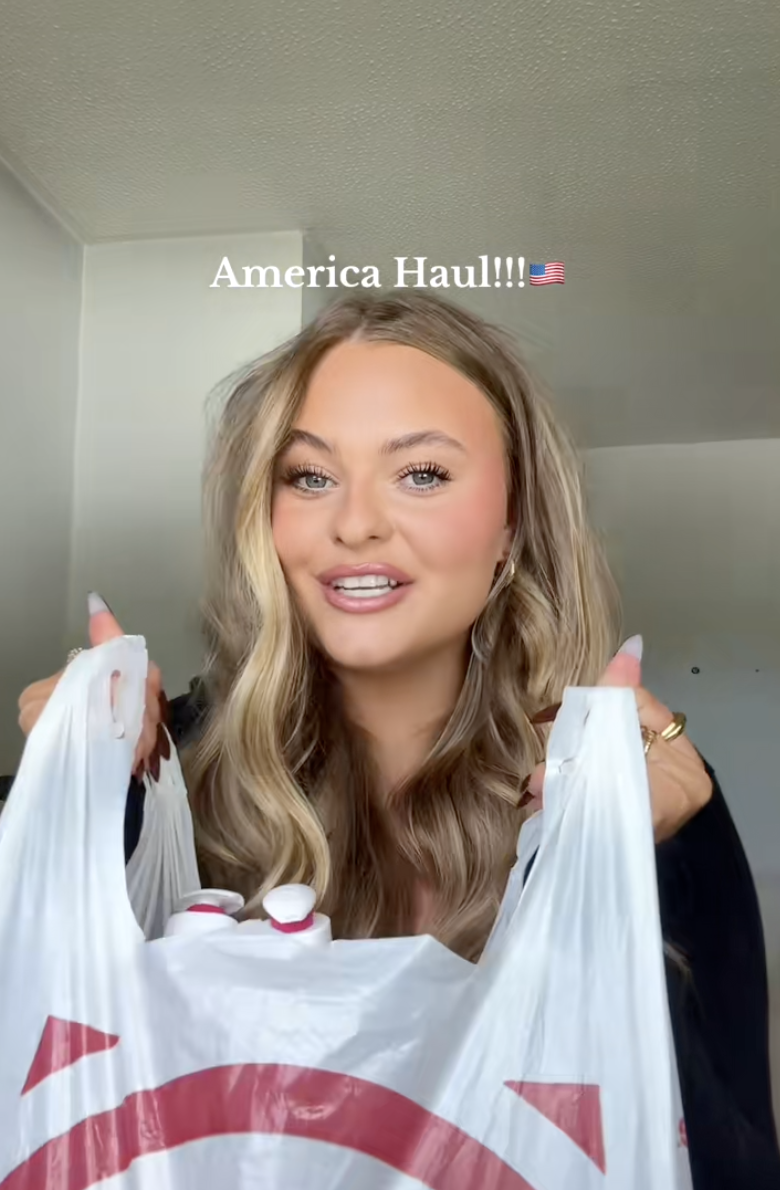 Person holding shopping bags, smiling, with the text &quot;America Haul!!! ??&quot; displayed above. Suitable for an article in Work &amp;amp; Money