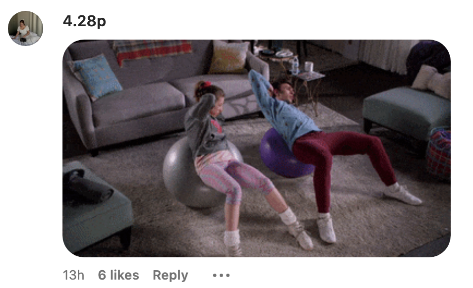 Two people are exercising on stability balls in a living room. They are wearing casual workout clothes