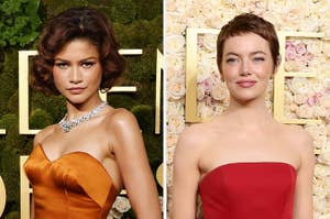 Two women on a red carpet; one in a strapless orange gown with a necklace, the other in a strapless red gown, both with styled short hair