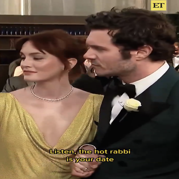 A man in a tuxedo with a white rose and a woman in an elegant gown are on a red carpet. Caption reads: "Listen, the hot rabbi is your date."