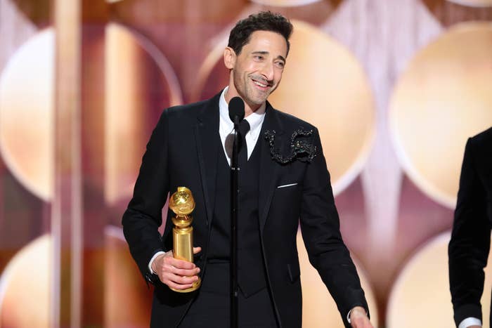 Adrien Brody onstage with his Golden Globe award