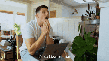 Person looking surprised at a laptop screen in a home setting, with text &quot;It&#x27;s so bizarre, man&quot; appearing below