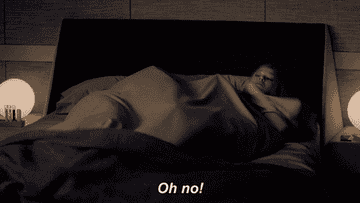 A person lying in bed quickly sits up, looking surprised or alarmed. The text at the bottom reads, &quot;Oh no!&quot;