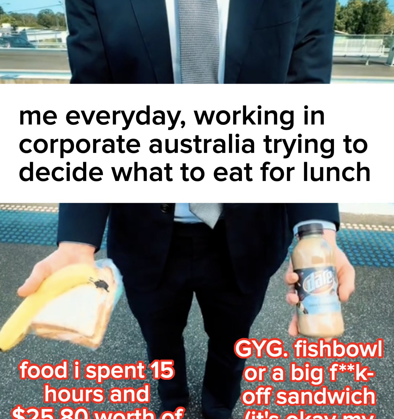 A person in a suit holds a sandwich and a bottle of chocolate milk at a train station platform