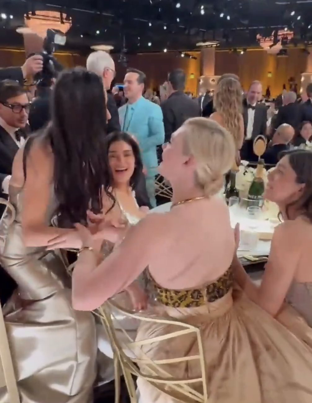 Demi Moore and Elle Fanning speaking at the Golden Globes while Kylie Jenner looks on