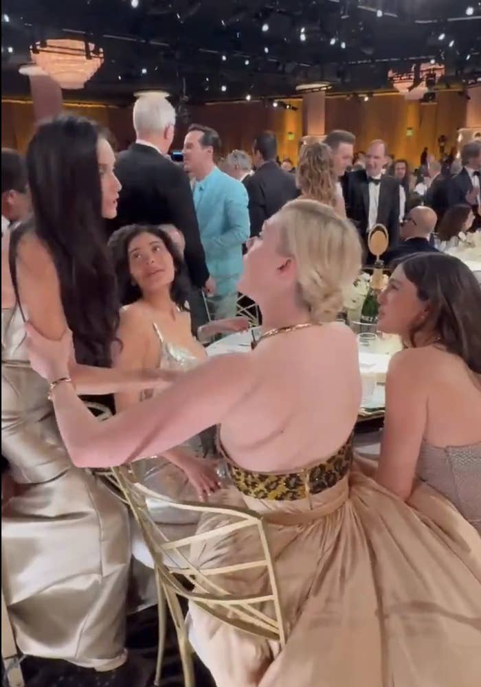 Demi Moore and Elle Fanning speaking at the Golden Globes while Kylie Jenner looks on