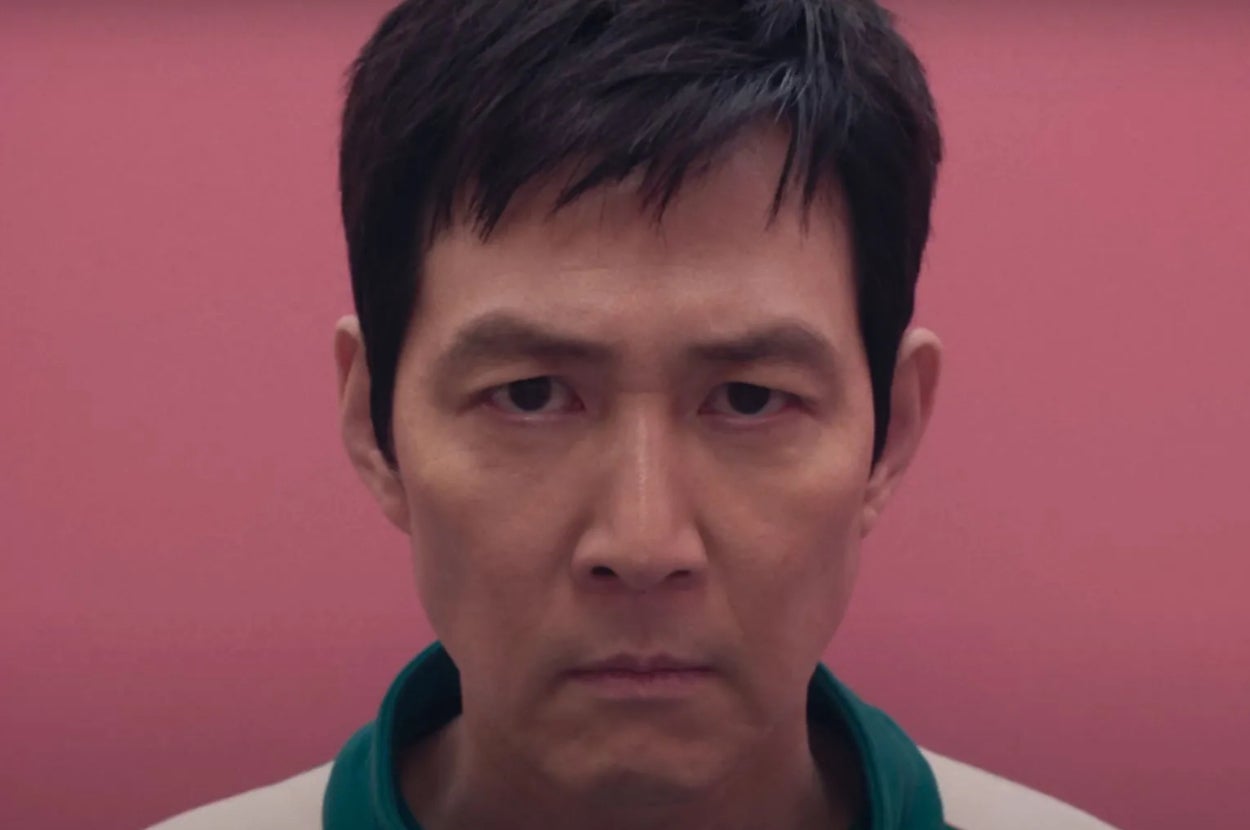 Person staring intensely forward with a neutral expression, against a plain background